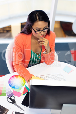 Female graphic designer working on computer