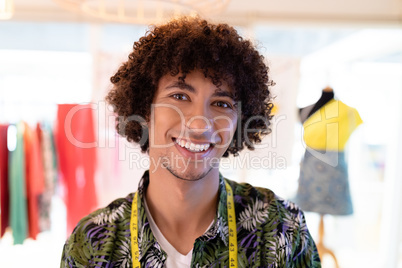 Male fashion designer smiling in design studio