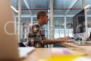 Male graphic designer working on computer at desk