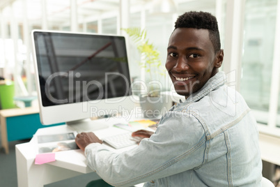 Male graphic designer working on computer at desk