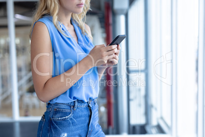 Businesswoman using mobile phone in a modern office