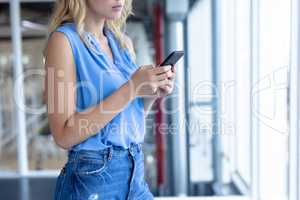 Businesswoman using mobile phone in a modern office
