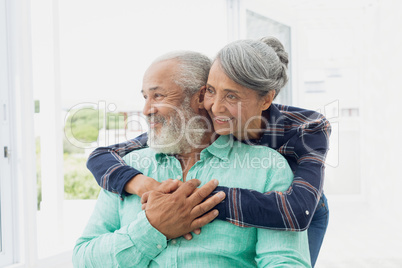 Couple smiling inside a room