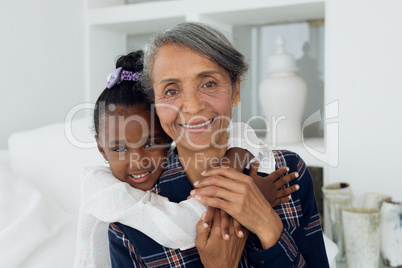 Grandmother and granddaughter smiling