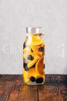 Bottle of Water with Orange and Blackberry.