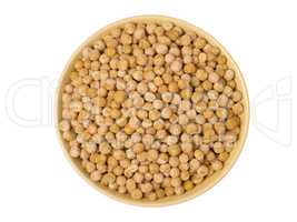 Bowl of yellow dried chickpeas on white background.