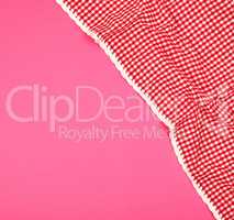 white red checkered kitchen towel on a pink background