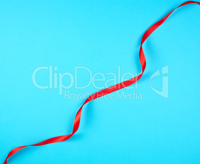 twisted red silk ribbon, blue background