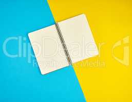 open spiral notebook with blank white pages