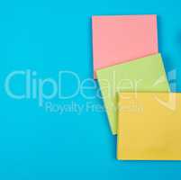 multicolored empty paper square stickers on blue background