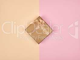 closed square box with a bow on an abstract colored background