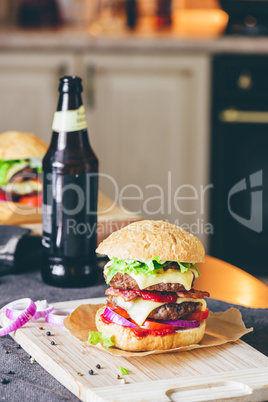 Cheeseburger with  Bottle of Beer and Some Ingredients.