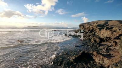 Stone cliffs, ocean waves and oceanscape. Punta jandia, Fuertaventura, Spain
