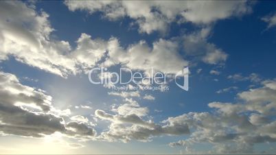 Time lapse clip of white fluffy clouds over blue sky