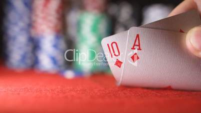 Poker player showing good card combination, ace and ten in slow motion