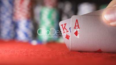 Poker player showing good card combination, ace and king in slow motion