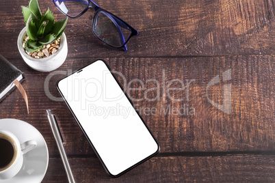 Working table with smart phone notepad coffee cup pen glasses pl