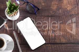 Working table with smart phone notepad coffee cup pen glasses pl