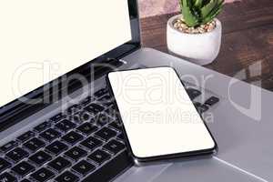 Smartphone white blank screen on laptop keyboard