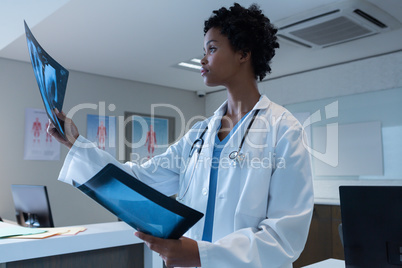 Female doctor examining x-ray in the hospital