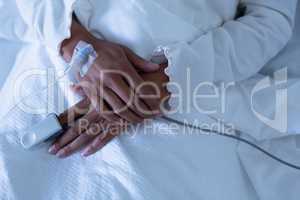 Female patient lying on the bed of hospital