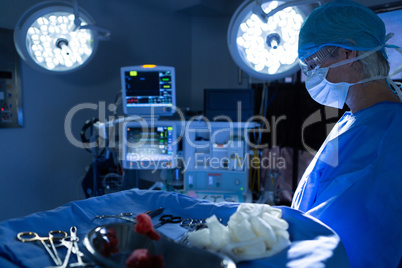 Male surgeon performing operation in operation room