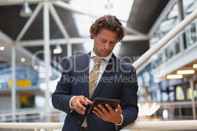 Businessman using digital tablet in the corridor at modern office Businessman using digital tablet in the corridor at modern office