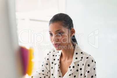 Female graphic designer working on at desk