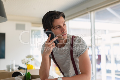 Male executive talking on mobile phone in the conference room at office