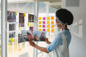 Female graphic designer checking photos in office