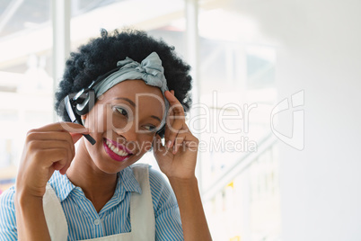 Female customer service executive talking on headset in office