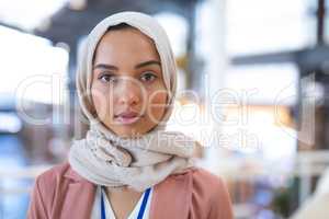 Businesswoman in hijab looking at camera in a modern office