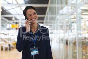 Businesswoman talking on mobile phone in a modern office