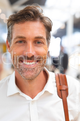 Happy businessman looking at camera in a modern office