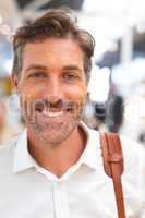 Happy businessman looking at camera in a modern office