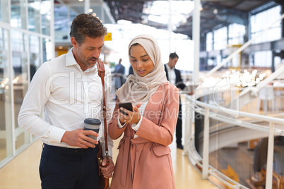 Business people discussing over mobile phone in a modern office