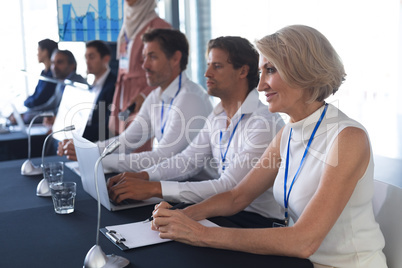 Business people sitting together at table in conference