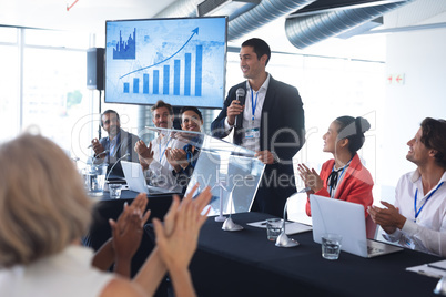 Audience applauding while speaker speaks in a business seminar