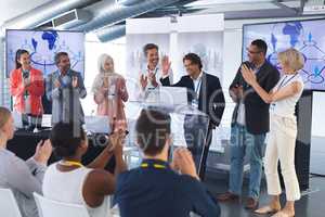 Businessman standing with colleagues and speaks in a business seminar