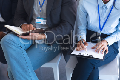 Business people noting and reading in a business seminar