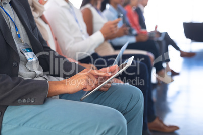 Businessman using digital tablet in business seminar
