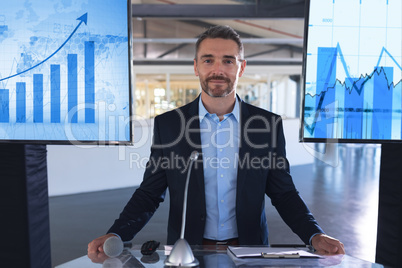Male speaker looking at camera while standing at podium in business seminar
