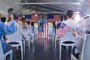 Business people waving an American flag in business seminar