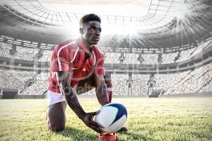 Composite image of african-american rugby player on field