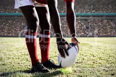 Composite image of multi-ethnic rugby players on field