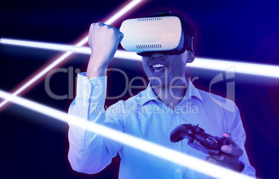 Composite image of happy businessman with vr glasses clenching fist while playing video game