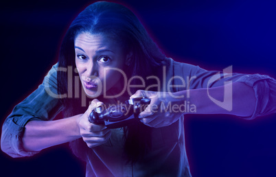 Composite image of woman making funny faces while playing video games