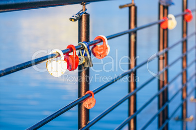 Metal locks hanging on railings.