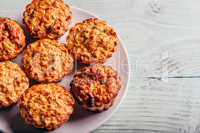 Cooked oatmeal muffins on white plate.