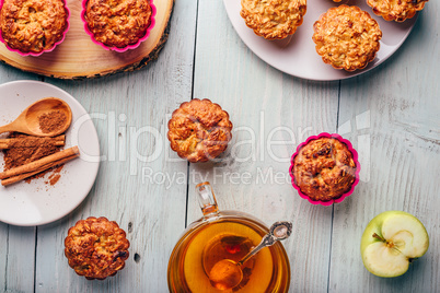 Oatmeal muffins with apple and cup of green tea.